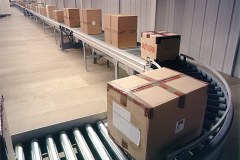 Roller conveyor transporting parcels at Faith, Rushden