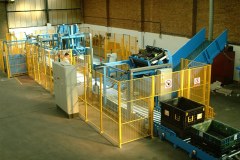 Mechanical handling system empties containers of waste, folds them in the correct sequence and stacks them ready for distribution at Ford