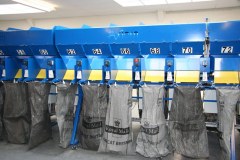 Postal sacks hang either side of the sortation system ready for filling